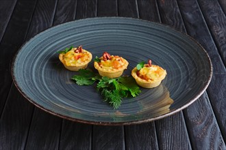 Appetizer for reception. Tartlet with bacon
