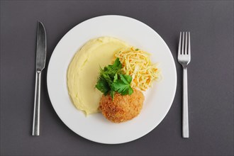 Top view of chicken Kiev cutlet with mashed potato on a plate
