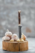 Garlic cloves and bulbs on wooden cutting board