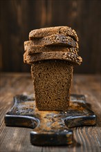 Closeup view of fresh rye brown bread on wooden cutting board
