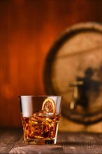 Cocktail old fashioned with barrel on background