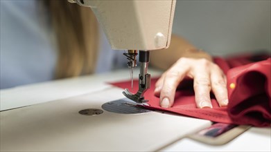 Close up hands sewing with machine
