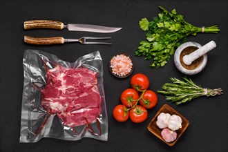 Vacuum sealed lamb shoulder with ingredients for cooking
