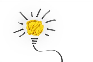 Idea concept with light bulb made out of yellow crumbled paper ball and drawn black lines on white background