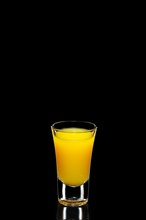 Fresh orange juice as ingredient for vodka cocktail isolated on black