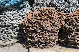 Heap of rusty metal chain seen on the background