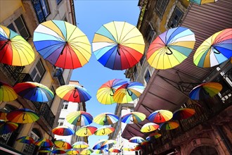 Colorful umbrellas suspended over Pink Street