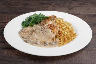 Spicy chicken fillet with risotto and mushroom sauce