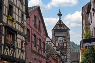 Colourful half-timbered houses with old tower of the historic old town of Riquewihr