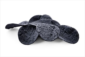 Black crispy spicy potato chips isolated on white background with full depth of field