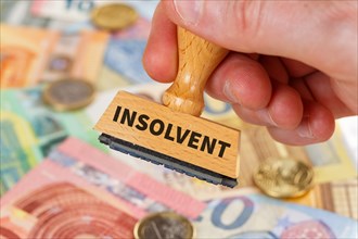 Insolvent on stamp symbol image insolvency bankruptcy debt finance and economy money crisis as business concept in Stuttgart