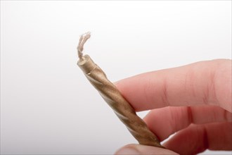 Gold colorl candle stick in hand on a white background