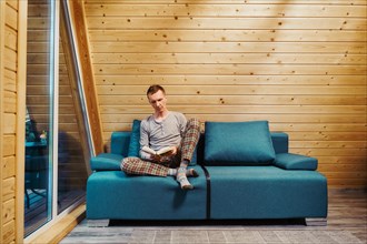 Man sits on sofa and reading a book