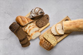 Assortment of cereal bread made of different seeds on wooden table