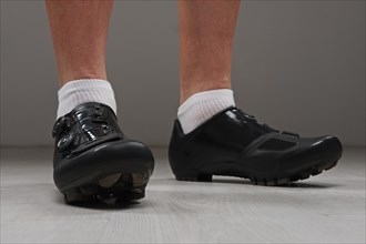 Low point of view of male legs in cycling boots