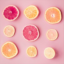Slices fresh citrus fruits pink background. Resolution and high quality beautiful photo