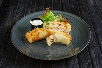 Pancake with chicken and cheese with salad and sour cream