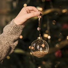 Lady holding ornament transparent christmas ball