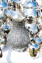 Ancient metal jug in oriental style in antique market