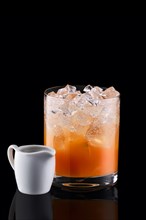Espresso tonic with sea buckthorn syrup isolated on black background