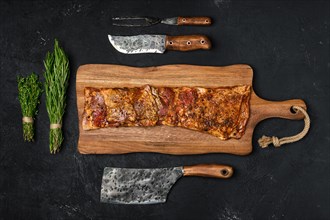 Top view of grilled lamb breast ribs on wooden cutting board