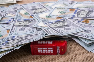 Model telephone booth is covered by the spread US dollar Banknotes