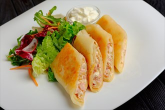 Pancakes with ham and salad