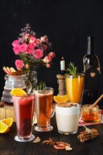 Composition with herbal and fruit hot alcohol drinks with ingredients on the table
