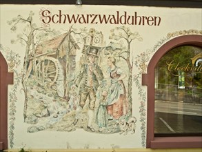 Watch wearer depicted in a facade painting of a Black Forest watch shop in Triberg