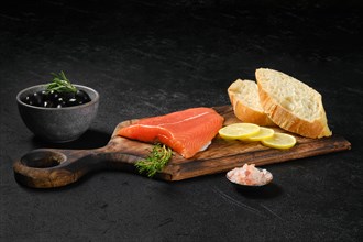 Piece of fresh salmon steak with ciabatta and spicy herb sauce