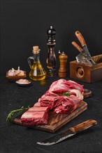 Raw fresh beef short rib stripes on wooden cutting board