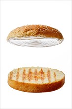 Two pieces of a bun with sesame seeds for burger