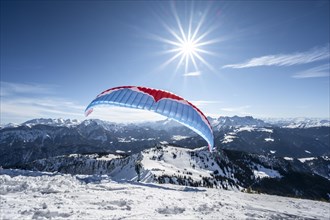 Paraglider at take-off in winter