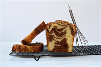 Marble cake with whisk on cake rack