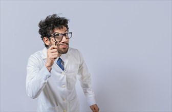 Mad scientist holding a magnifying glass isolated