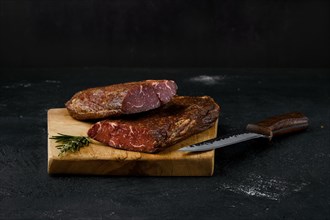 Smoked beef striploin meat on cutting board