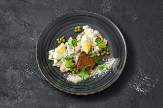 Top view of olivier salad with black bread