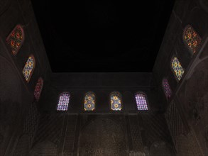 Colourful mosaic windows in the dark