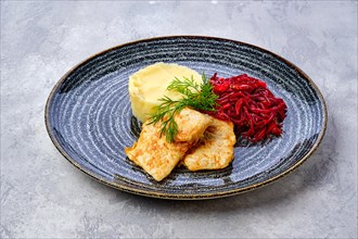 Fried hake in breading with mashed potato and roasted beetroot