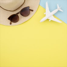 Flat lay yellow background with hat glasses
