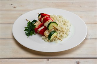 Grilled fish and vegetables on skewer with boiled rice