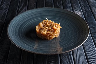 Plate with onion marmalade. Candied onion jelly