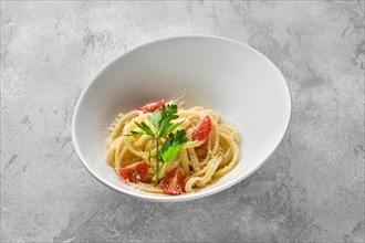 Plate with noodles with parmesan cheese and tomato