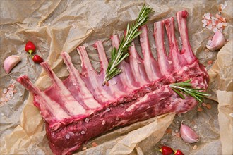 Closeup overhead view of raw fresh rack of lamb in wrapping paper