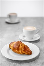 Cappuccino and croissant on a table