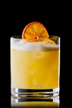 Variation of whiskey sour cocktail with orange syrup isolated on black background