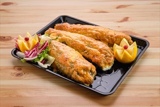 Baked fish in batter on tray