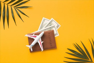Flat lay passport with money plane figurine top
