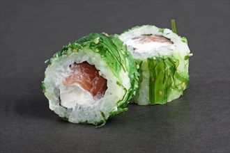 Rolls with tuna in green seawed with nut sauce