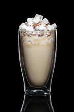 Double walled glass with coffee cocktail decorated with whipped cream and marshmallows isolated on black